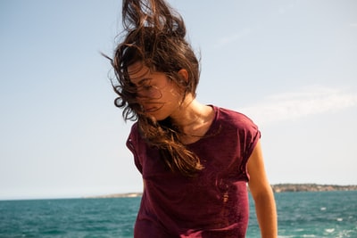 A woman standing to blow hair
